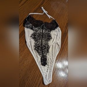 Woman's white sheer bodysuit lingiere with black lace